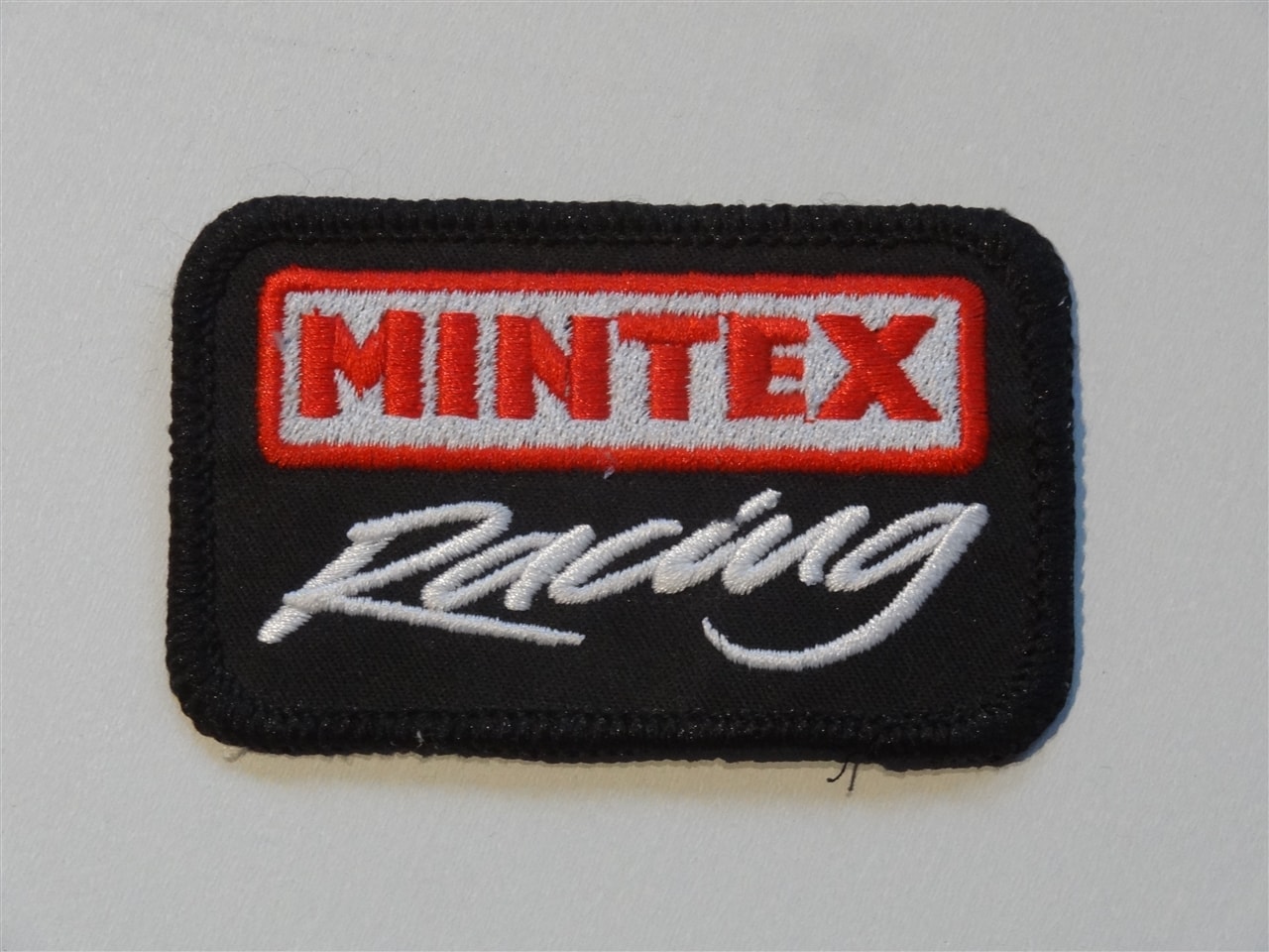 Opnaai Embleem Mintex racing - ASF racing productions